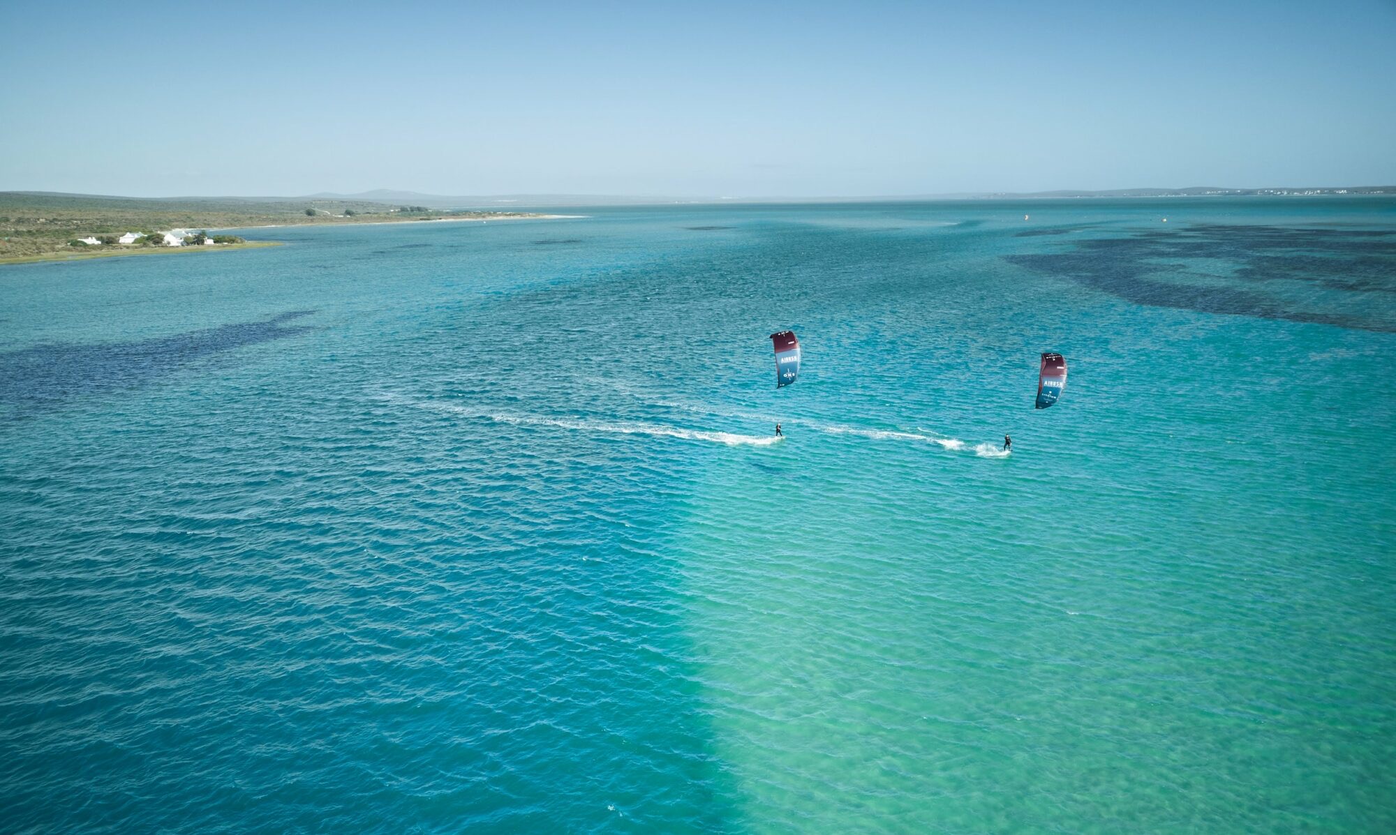 Kitesurfers on the turquoise Langebaan Lagoon, seen from above