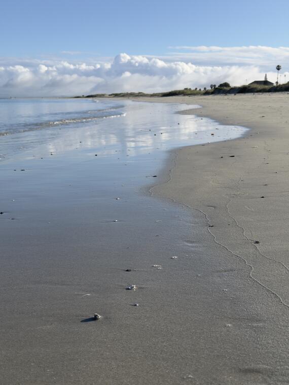 Wet sand and clouds on Langebaan main beach