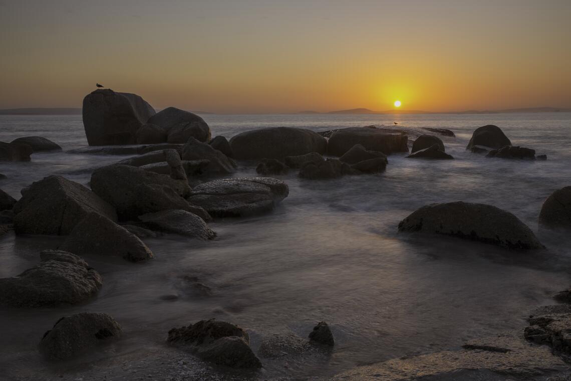 Sunset over rocks on the West Coast