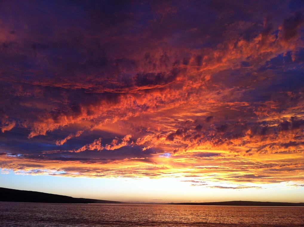 A fiery orange sunset over the sea